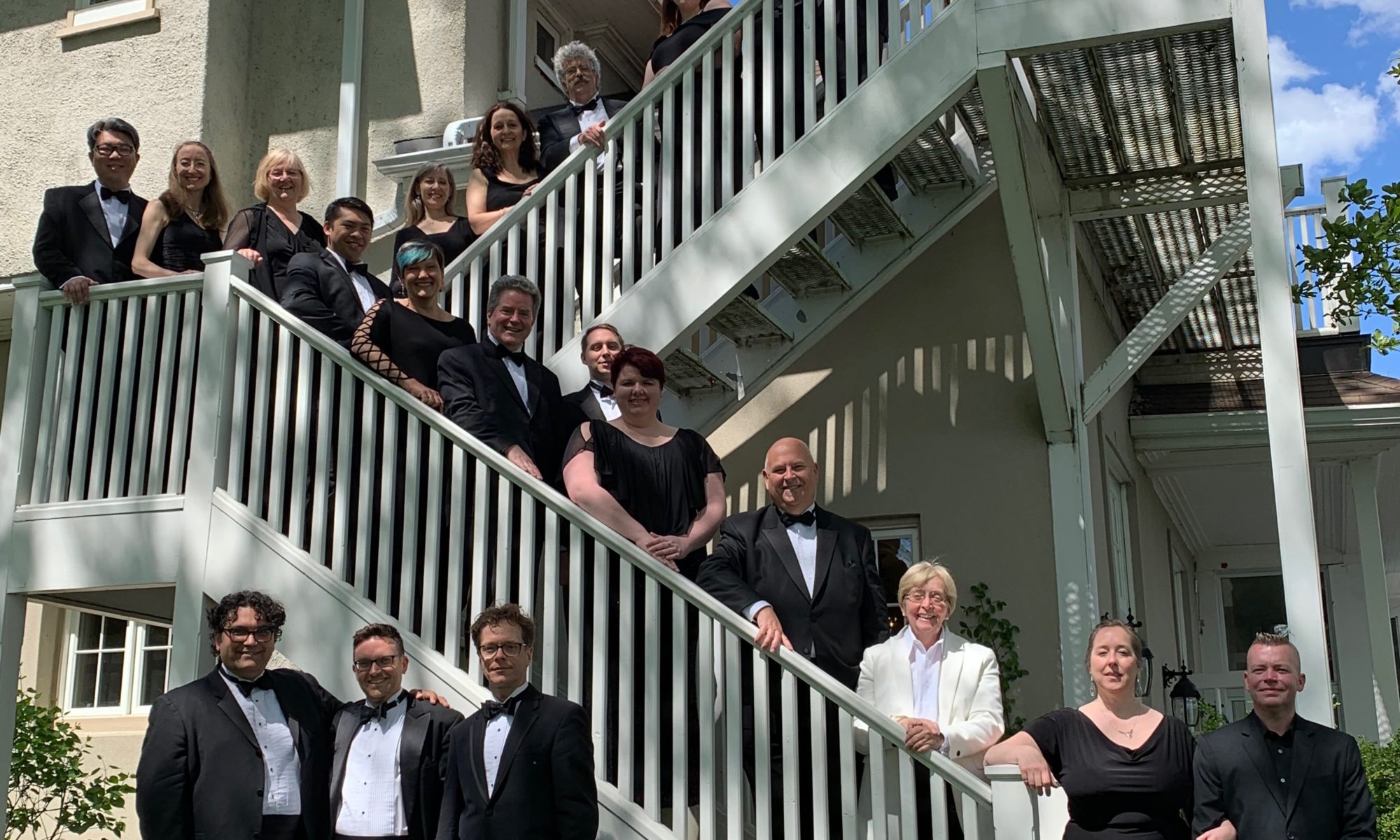 Elmer Iseler Singers along a staircase at the Toronto Hunt Club